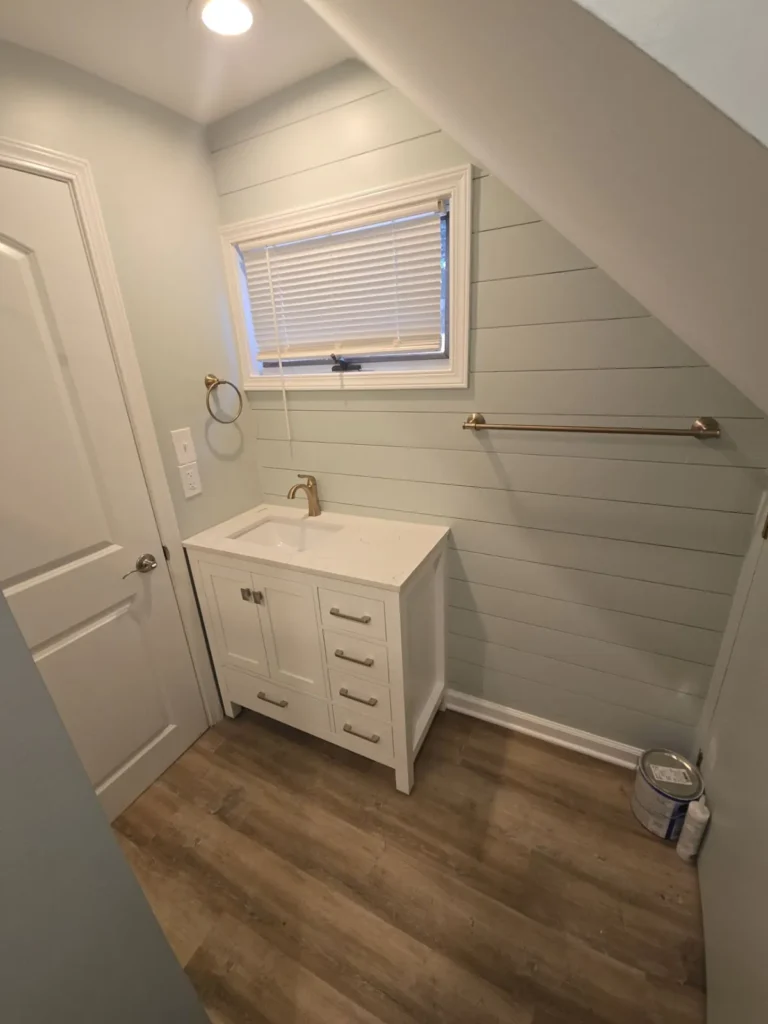 Bathroom remodel with shiplap wall, new vanity and LVP floor by Stoney Creek Construction in Rome City, Indiana
