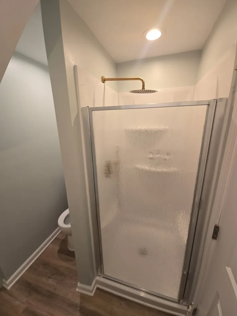Remodeled bathroom with new walk-in shower and rain shower head by Stoney Creek Construction in Rome City, Indiana