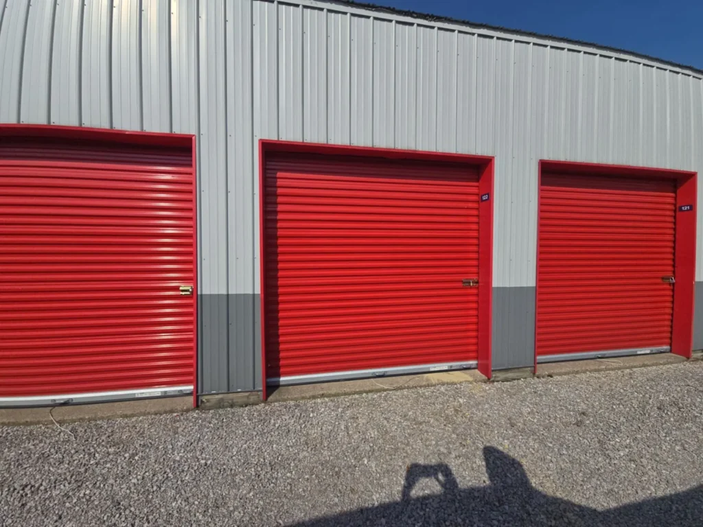 New steel-sided storage building with red roll-up doors built by Stoney Creek Construction in Northeast Indiana
