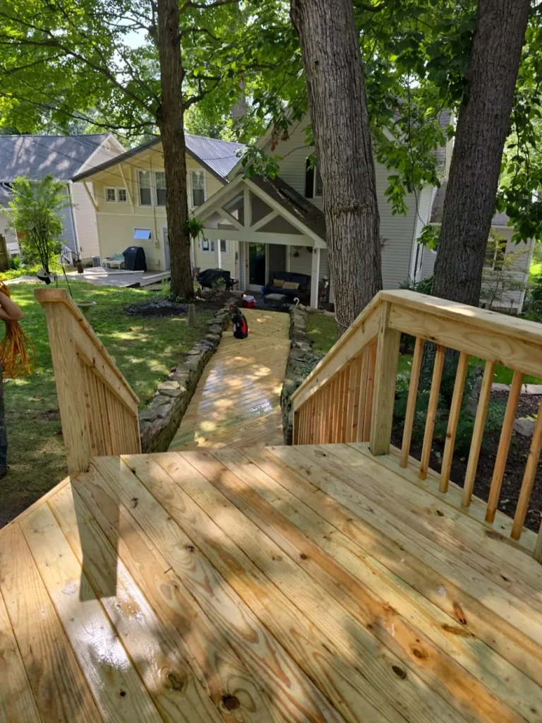 New pressure-treated pine deck with railings and walkway built by Stoney Creek Construction in Rome City, Indiana